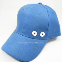 Interchangeable customizable cap that has two charm holders in front where you can snap in and snap out different charms . You can basically turn one cap into 50 with just the snap of a charm. See our Sandy Snap Charms to choose the look for you!